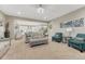 Comfortable living room with plush seating, neutral tones, and seamless access to the kitchen at 6470 Amur Ct, Castle Rock, CO 80108