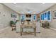 Spacious living room with a fireplace, large windows, plush seating, and stylish decor at 6470 Amur Ct, Castle Rock, CO 80108