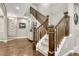 Elegant staircase with wooden banister, carpeted steps, and decorative wall accents at 6470 Amur Ct, Castle Rock, CO 80108