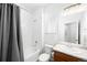 Bright bathroom with a shower-tub combo, modern vanity, and fresh white tile at 47 N Uriah St, Aurora, CO 80018