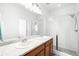 Bright and spacious bathroom featuring double sinks, modern vanities, and a glass-enclosed shower at 47 N Uriah St, Aurora, CO 80018