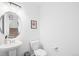 Well-lit half bathroom with a modern vanity and neutral decor at 47 N Uriah St, Aurora, CO 80018