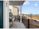 Inviting front porch with a cozy hanging chair and views of the surrounding community at 47 N Uriah St, Aurora, CO 80018