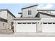 Modern townhouse featuring a spacious two car garage with a concrete driveway at 47 N Uriah St, Aurora, CO 80018