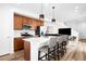 Stylish kitchen featuring stainless steel appliances, white countertops, and an island with seating at 47 N Uriah St, Aurora, CO 80018