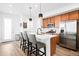 Modern kitchen with an island, stainless steel appliances, and stylish pendant lighting at 47 N Uriah St, Aurora, CO 80018