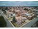 Expansive aerial view showcases a luxury home with beautiful landscaping surrounded by a mature neighborhood and city views at 115 S Jasmine St, Denver, CO 80224