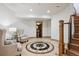 Finished basement with a decorative compass floor design and adjacent staircase at 115 S Jasmine St, Denver, CO 80224