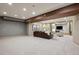 Large basement area with neutral carpet, brown leather sofa and entertainment center at 115 S Jasmine St, Denver, CO 80224