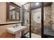 Luxurious bathroom featuring a glass-enclosed shower with decorative tile and elegant fixtures at 115 S Jasmine St, Denver, CO 80224
