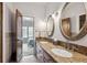 Elegant bathroom with double sinks, granite countertop, and decorative mirrors at 115 S Jasmine St, Denver, CO 80224