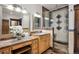 Elegant bathroom featuring a marble vanity top, wood cabinets, and an ornate tiled shower with glass enclosure at 115 S Jasmine St, Denver, CO 80224