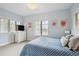 Charming bedroom with blue accents, a large window, and a television on a dresser at 115 S Jasmine St, Denver, CO 80224