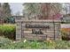 Charming Crestmoor Park sign with stone accents and lush greenery, welcoming residents and visitors to the neighborhood at 115 S Jasmine St, Denver, CO 80224