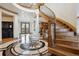 Grand foyer featuring a swirling staircase, a starburst-patterned marble floor, and soaring ceilings at 115 S Jasmine St, Denver, CO 80224