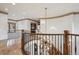 Grand foyer featuring a curved staircase, decorative iron railing, and unique chandelier at 115 S Jasmine St, Denver, CO 80224