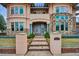 Elegant home entrance featuring stone walkway, manicured landscaping, and a custom address marker at 115 S Jasmine St, Denver, CO 80224