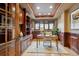 Spacious home office with custom wood built-ins, a large window, and natural light at 115 S Jasmine St, Denver, CO 80224
