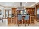 Kitchen island with granite countertops, seating, and custom cabinetry, perfect for entertaining at 115 S Jasmine St, Denver, CO 80224