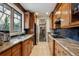 Gourmet kitchen with granite countertops, wood cabinetry, and stainless steel appliances at 115 S Jasmine St, Denver, CO 80224