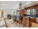 Open concept kitchen features a center island, granite countertops, and an adjacent dining area at 115 S Jasmine St, Denver, CO 80224