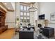 Elegant living room with a fireplace, soaring ceilings, large windows, and stylish furniture at 115 S Jasmine St, Denver, CO 80224