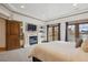 Inviting primary bedroom with fireplace, balcony access, and bright natural light at 115 S Jasmine St, Denver, CO 80224