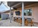 Outdoor kitchen featuring a built-in grill, bar seating, and a covered patio area at 115 S Jasmine St, Denver, CO 80224