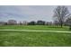 Expansive green space in the park provides a serene escape with mature trees and a walking path for recreation and relaxation at 115 S Jasmine St, Denver, CO 80224