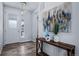 Light and airy entryway with a console table and view to kitchen at 39283 Hart Cir, Elizabeth, CO 80107