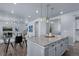 Kitchen island with seating and a view into the living room at 39283 Hart Cir, Elizabeth, CO 80107