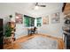 Bedroom with hardwood floors, large windows, and a desk workspace at 1218 S University Blvd, Denver, CO 80210