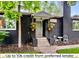 Charming entrance with black brick, front porch, and flowers, leading into a cozy home at 1218 S University Blvd, Denver, CO 80210