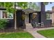 Close-up of home's entrance, showcasing the walkway, front door, and hanging flower baskets at 1218 S University Blvd, Denver, CO 80210