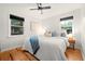 Serene bedroom with hardwood floors, ample natural light, and a comfortable bed with stylish pillows at 1218 S University Blvd, Denver, CO 80210