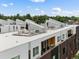 An aerial view shows the modern rooftop patios that provide stunning views and a great entertaining space at 3233 Tejon St # 305, Denver, CO 80211