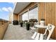 Relax on this balcony featuring outdoor seating, grill, and sliding glass doors for indoor/outdoor living at 3233 Tejon St # 305, Denver, CO 80211