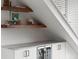 Stylish bar area featuring floating shelves, white cabinets, marble countertop, and a wine fridge at 3233 Tejon St # 305, Denver, CO 80211