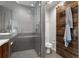 Elegant bathroom with a frameless glass shower, and a stylish wooden sliding door at 3233 Tejon St # 305, Denver, CO 80211