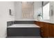 Relaxing bathroom with a soaking tub, wood cabinets, and modern fixtures at 3233 Tejon St # 305, Denver, CO 80211