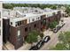 Modern townhome exterior with unique architecture, a rooftop deck, and private entrances on a tree-lined street at 3233 Tejon St # 305, Denver, CO 80211