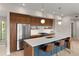 Contemporary kitchen with a large island, stainless steel appliances, wood cabinets, and pendant lighting at 3233 Tejon St # 305, Denver, CO 80211