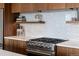 Modern kitchen featuring stainless steel appliances, gas range, quartz countertops, and stylish wood cabinetry at 3233 Tejon St # 305, Denver, CO 80211