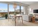 Bright living room boasts a dining area, cozy sofa, and expansive windows with city views at 3233 Tejon St # 305, Denver, CO 80211