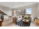Spacious living room with an open layout, connecting stairs, dining area, and a comfortable seating area at 3233 Tejon St # 305, Denver, CO 80211