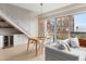 Open living room features stairs, a dining table, and floor-to-ceiling windows for ample natural light at 3233 Tejon St # 305, Denver, CO 80211