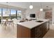 Open living and dining area featuring a kitchen island, hardwood floors, and floor-to-ceiling windows at 3233 Tejon St # 305, Denver, CO 80211
