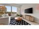 Chic living room offering a large sofa, accent rug, and scenic views from expansive windows at 3233 Tejon St # 305, Denver, CO 80211