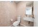 Charming powder room featuring unique wallpaper, floating sink, and elegant fixtures at 3233 Tejon St # 305, Denver, CO 80211