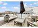 Inviting rooftop deck with comfortable seating, an umbrella, and city skyline views at 3233 Tejon St # 305, Denver, CO 80211